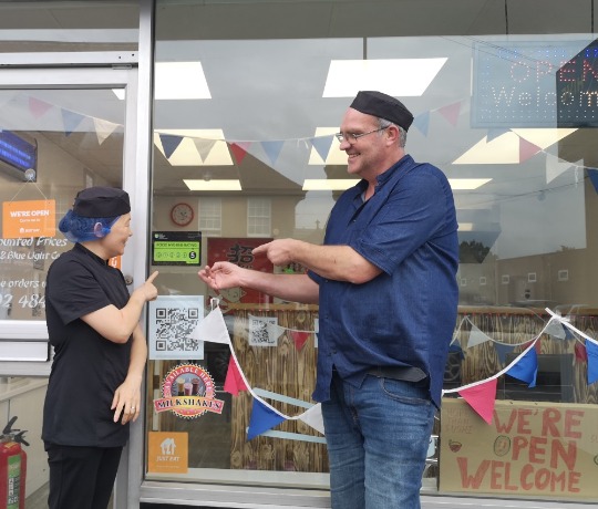 Photo of two people showing their 5 star hygiene rating