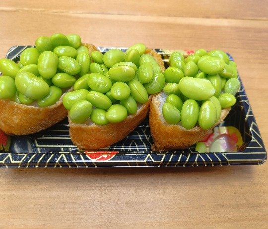 Rice Inside Fried Sweet Tofu Pouch  Topped With Edamame