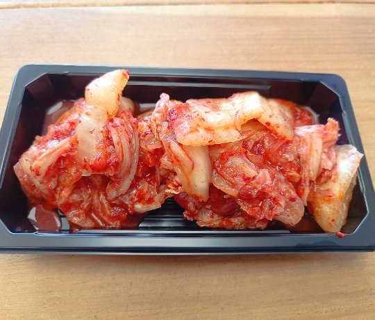 Yummy Kimchi Kimchi is made from Chinese cabbage, salt, garlic, ginger, and chili. It has a spicy, sour, and slightly tangy flavour.